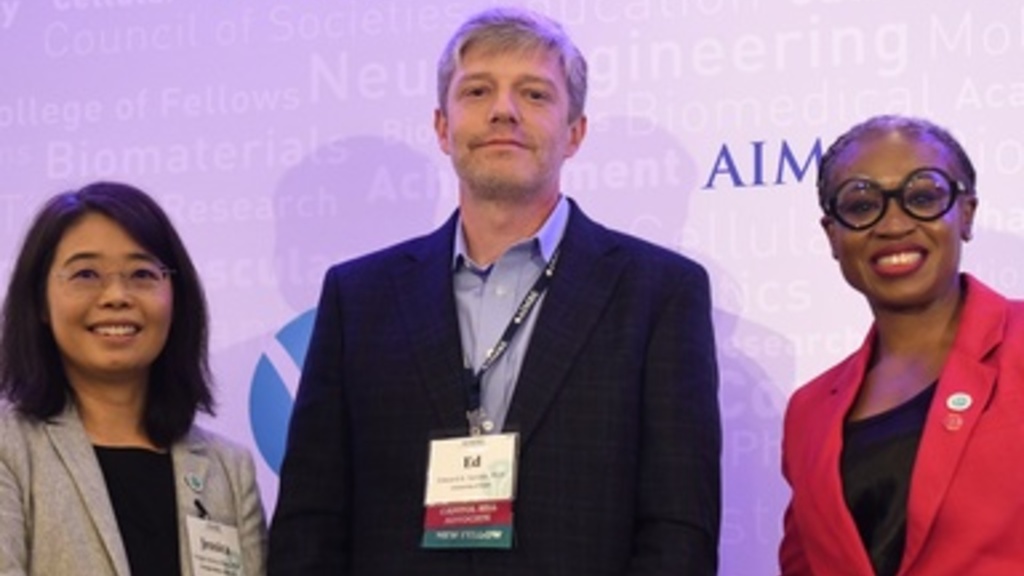 Edward Sander poses for a photo with his award